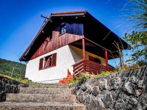 a house with stairs leading up to it at Casa Kolpa in Dragatuš