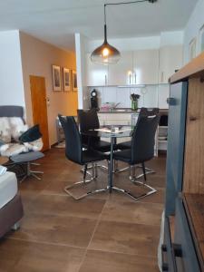 a kitchen and living room with a table and chairs at Fewo Regina in Sankt Englmar