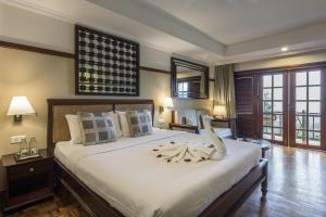 a bedroom with a large bed with a snake on it at Club Mahindra Lake View Munnar in Chinnakanal +32 photos