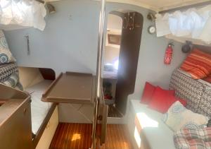 a small room with two beds and a desk at Voilier à Porquerolles in Hyères +24 photos