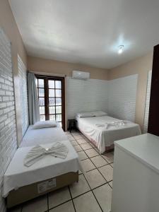 Ein Bett oder Betten in einem Zimmer der Unterkunft Hotel D'Luz