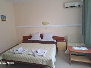 a small room with two beds and a table at Guest House Paskal in Sunny Beach