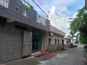 an empty street next to a brick building at Stay Reliable in Udaipur