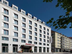 a large white building with windows on a street at Hampton By Hilton Dresden City Centre in Dresden
