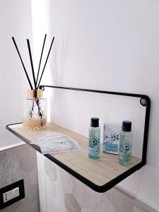 a glass shelf with two bottles on top of it at La Siesta 5 terre in La Spezia +43 photos