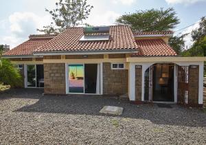 a house with a solar panel on top of it at Nairobi inn in Nairobi