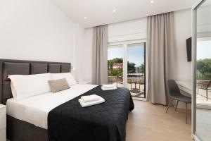 a bedroom with a bed with two towels on it at Villa Hidden with heated pool in Dobrinj +35 photos