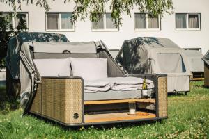 a bed in the grass in front of a tent at Hotel Mukran - Bikers Life in Sassnitz +6 photos