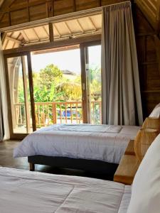 Ένα ή περισσότερα κρεβάτια σε δωμάτιο στο Puri Jineng Uluwatu 3 +29 φωτογραφίες