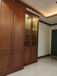 a large wooden closet with glass doors in a room at Dcarlton seaview apartment in Masai