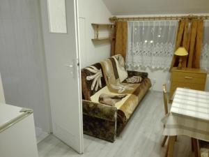 a living room with a couch and a window at Willa BIM in Rewal