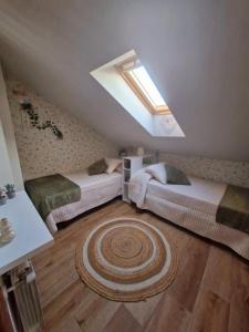 a attic bedroom with two beds and a skylight at "La casuca de Finu" #2# Santillana del Mar in Santillana del Mar +2 photos