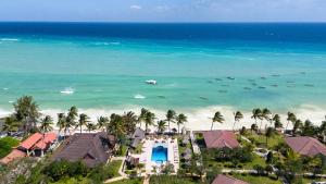 an aerial view of a beach with houses and boats at Mandarin Resort Zanzibar in Kizimkazi +59 photos