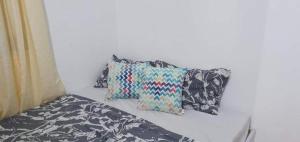 a group of pillows sitting on top of a bed at Near SM Lanang & Samal Wharf - 2BR Condo Davao - Netflix in Davao City +21 photos