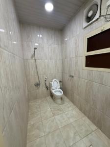 a bathroom with a toilet in a shower stall at قمة الفخامة للشقق المخدومة in Al Hofuf +9 photos