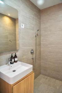 a bathroom with a white sink and a shower at Pavilion Bukit Jalil Revo Aurora Walk to Mall & Near Axiata Arena by D'Summer 28A in Kuala Lumpur +25 photos