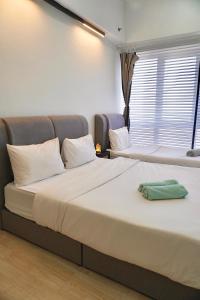 a bedroom with two beds and a window at Pavilion Bukit Jalil Revo Aurora Walk to Mall & Near Axiata Arena by D'Summer 28A in Kuala Lumpur