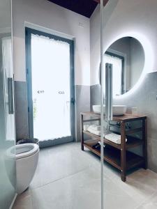 a bathroom with a toilet and a sink and a mirror at Deltasol in Montepulciano +41 photos