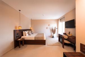 a large bedroom with a bed and a desk at ananea Hurghada - Adults Only in Hurghada