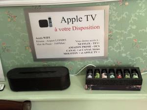 a row of bottles of apple tv on a shelf at Appartement Centre Ville in Mirepoix