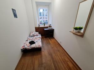 a room with a couch and a table and a window at Fantastic-Inn Warszawa - Czackiego in Warsaw