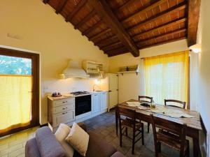 a kitchen and dining room with a table and a couch at Agriturismo Le Ceregne Bio in Pieve Santo Stefano