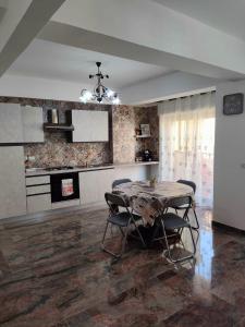 a kitchen and dining room with a table and chairs at Casa Vacanze A Due Passi Dal Mare in Furci Siculo
