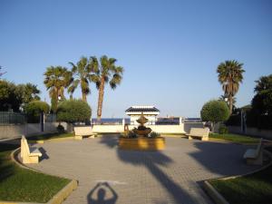 a park with a fountain and benches and palm trees at Residencial Veramar 4, Vera Playa, Almeria in Vera