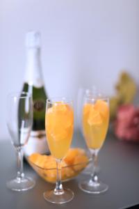 three glasses of orange juice and a bottle of wine at Hotel Toboso Chaparil in Nerja