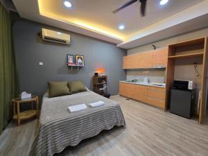 a bedroom with a large bed and a kitchen at 028 Projector Palazio Vintage House Netflix Wifi in Johor Bahru +3 photos
