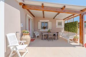 a patio with a table and chairs and a table and chairs at Dependance Nonna Rosa in Granelli