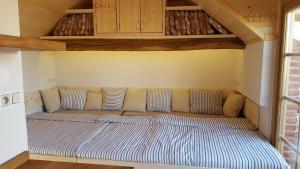 a bed in a room with two pillows on it at Apartmán Trojan in Hrušky
