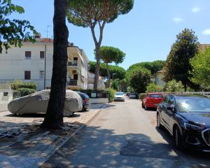 a street with cars parked next to a building at CV017 - Milano Marittima, elegante mansarda con aria condizionata in Cervia