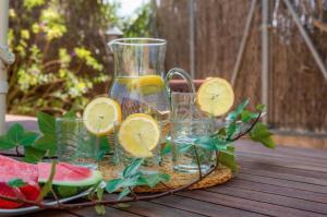 a glass pitcher of lemonade and glasses of watermelon at Casa Luz Cala Rajada in Cala Ratjada