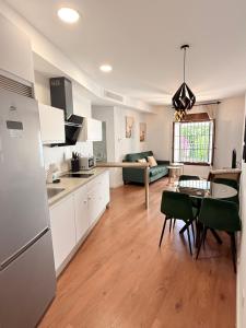 a kitchen and living room with a refrigerator and a table at Apartamentos Molinos in Constantina