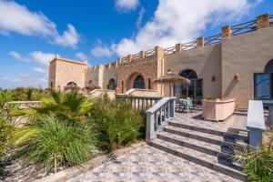a house on the beach with stairs and plants at Villa Sultana by Living Essaouira in Essaouira