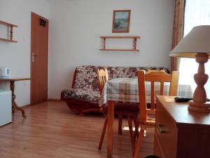 a living room with a table and a couch at Willa BIM in Rewal