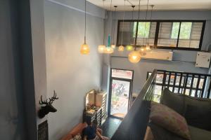 a man sitting on a couch in a living room at El Biografo in Bangkok