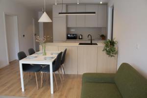a kitchen and dining room with a table and chairs at Hotel Taxis Bratislava - Suites in Bratislava