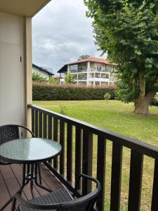 a table and chairs on a balcony with a building at CAPUCINES - T2 ANGLET avec stationnement in Anglet