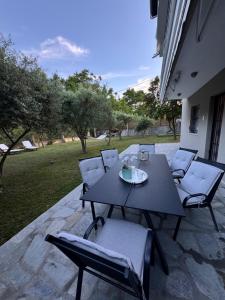 a black table and chairs on a patio at Elaia Stay in Nea Vrasna