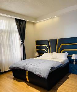 a bedroom with a large bed and a window at Agape Suites in Kampala