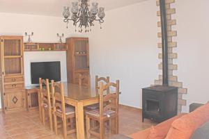 a dining room with a table and a wood stove at Chalet Arroyo Majadales 108 in Conil de la Frontera