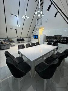a white table with black chairs in a kitchen at AFrame Gabala Azerbaijan FF in Gabala