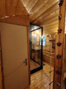 an open door in a wooden room with a glass window at Le refuge cévenol in Concoules +5 photos