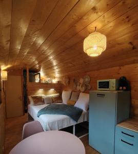 a bedroom with a bed in a wooden room at Le refuge cévenol in Concoules