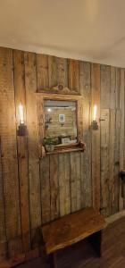 a wooden wall with a bench and a mirror at Katerina Boutique Apartment in Bansko +42 photos