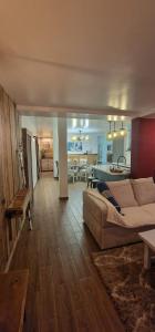 a living room with a couch and a dining room at Katerina Boutique Apartment in Bansko