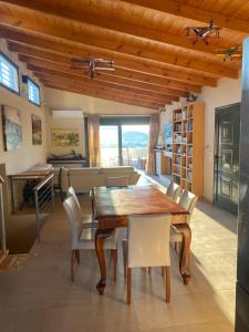 a dining room with a wooden table and chairs at EUPHORIA Pool Villa in Porto Rafti