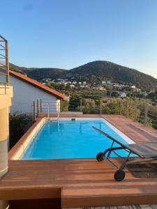 a swimming pool on the roof of a house at EUPHORIA Pool Villa in Porto Rafti